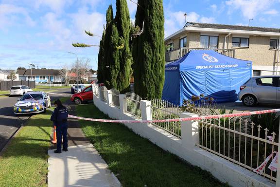 Guard officers, a police car, and specialist search group were seen outside the Clendon Park property after two hearses were transported out of it the previous day. Photo / Jed Bradley