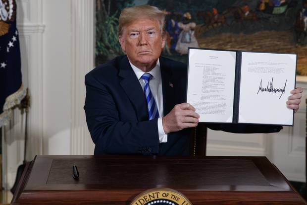 President Donald Trump shows a signed Presidential Memorandum after delivering a statement on the Iran nuclear deal. Photo / AP