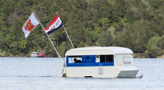Anglers enjoying the opening of the fishing season on Lake Tarawera near Rotorua today spotted this unusual craft trolling for fish! One of the flags says For Sale. Photo / Supplied