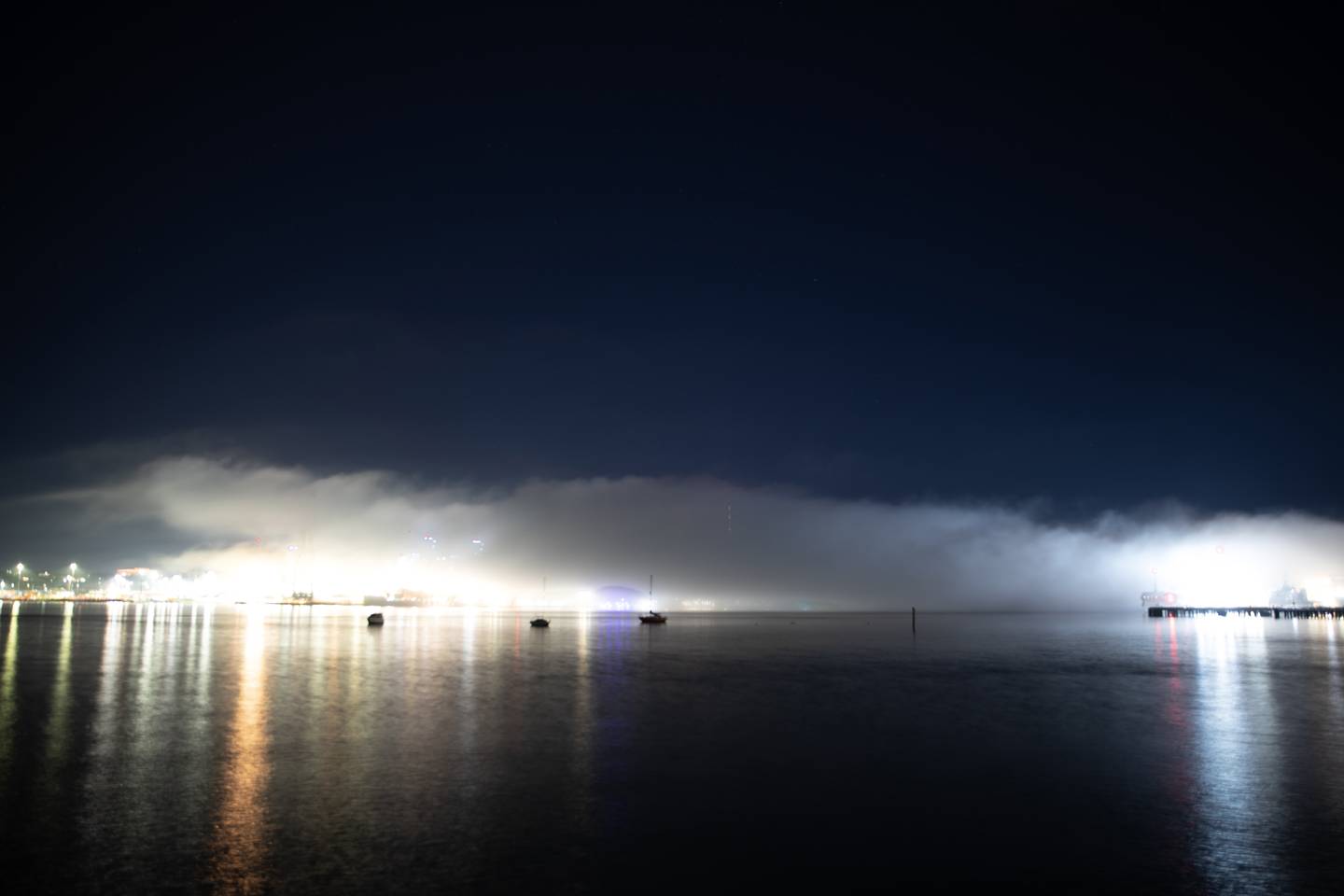 Auckland city covered in fog, looking across from Devonport. Photo / Hayden Woodward
