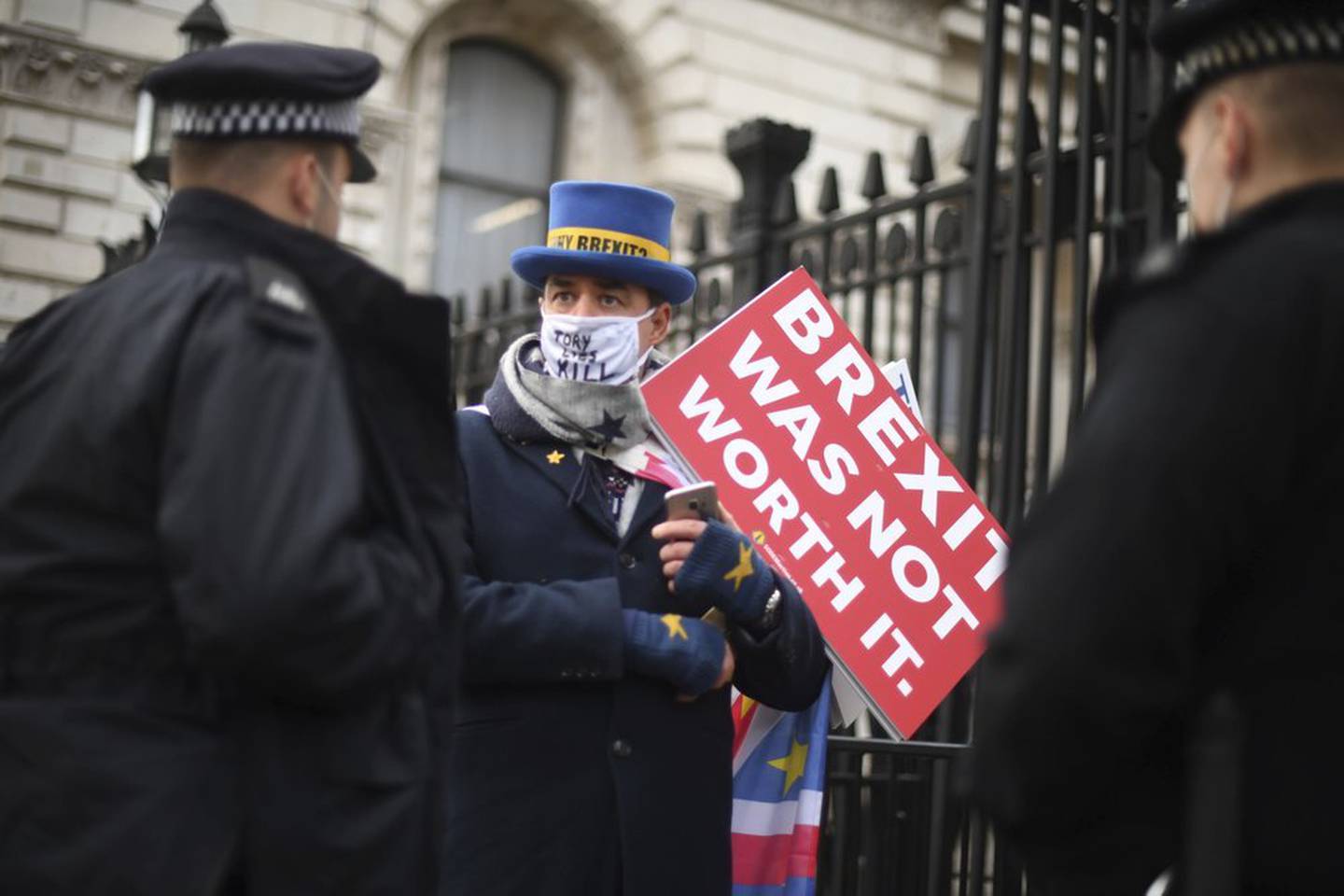 Police speak to anti-Brexit protestor Steve Bray at the gates of Downing Street, London. Photo / AP