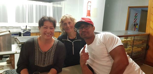 The late Pua Magasiva charming kitchen staff, Frances and Rosalie, at the Marist St Pats Rugby Club in Wellington during a recent visit. Photo / Supplied