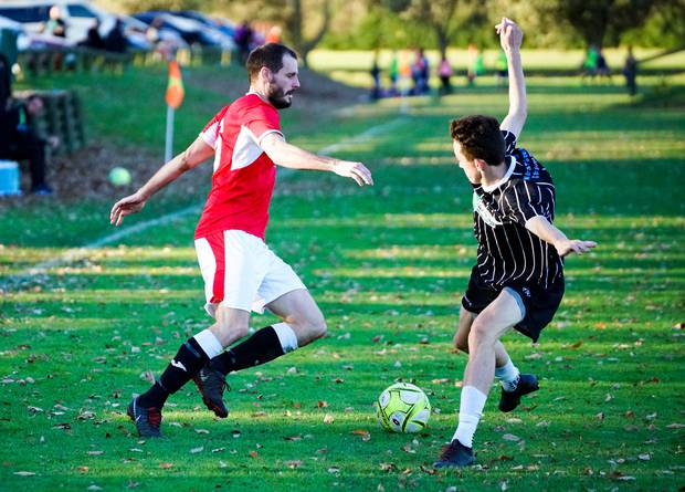 Athletic's James Satherley gets the better of Napier Marist goal scorer Luis Toomey. Photo/ Lewis Gardner 