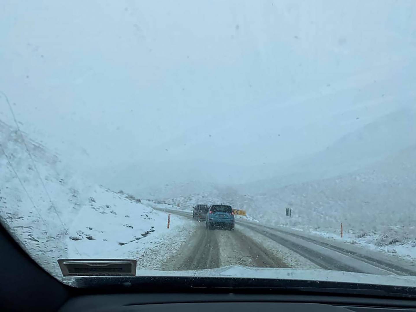 Snow falling on the Lindis Pass on August 7. Photo / Central Otago District Council