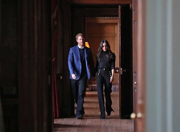 Prince Harry and Meghan Markle walk through the corridors of the Palace of Holyroodhouse. Photo / Getty Images