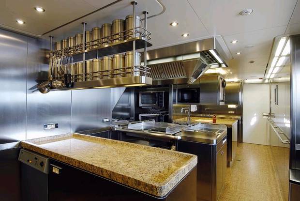 A stainless and granite kitchen of a superyacht. 