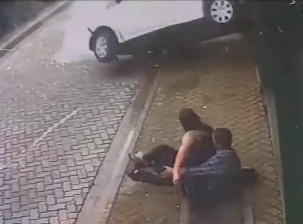 Crash: The car flies past them and crashes into a wall a few feet away, with the pair in shock on the ground. 