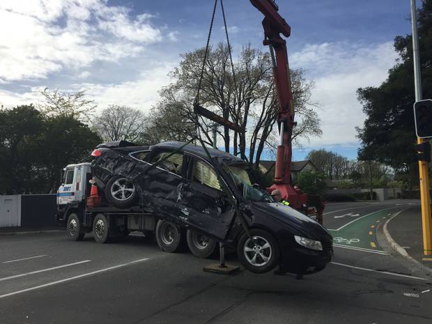 One of the damaged cars is removed from the scene. Photo / Rachel Das