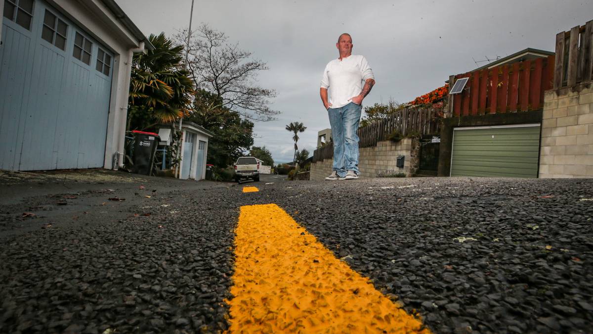 Napier man wakes to find yellow parking lines in front of hillside property,  ticket on car