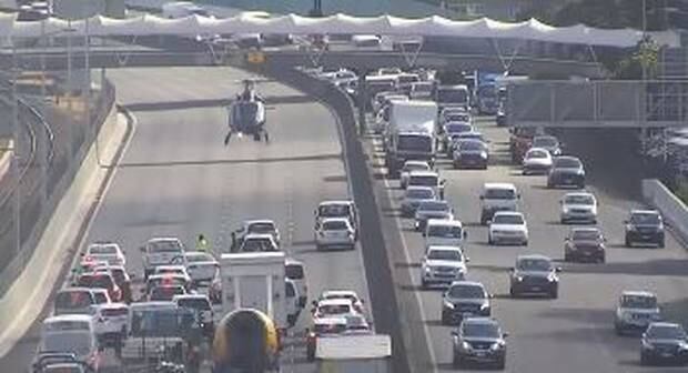 The police helicopter landed on the motorway.