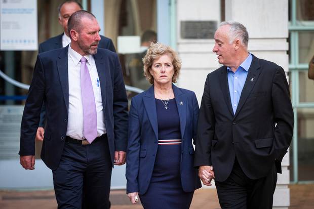 Grace Millane's parents Dave Gillian walk out from the Auckland High Court with Detective Inspector Scott Beard, left, after the jury delivered a murder verdict. Photo / Jason Oxenham