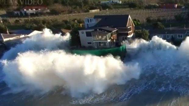 Drone footage captured huge swells crashing over houses in September. Photo / Supplied. 