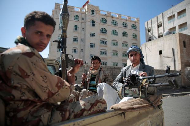 Shiite fighters, known as Houthis, pose for a photo as they secure a road, as people take part in a march from Sanaa to the port city of Hodeidah, Yemen. Photo / AP