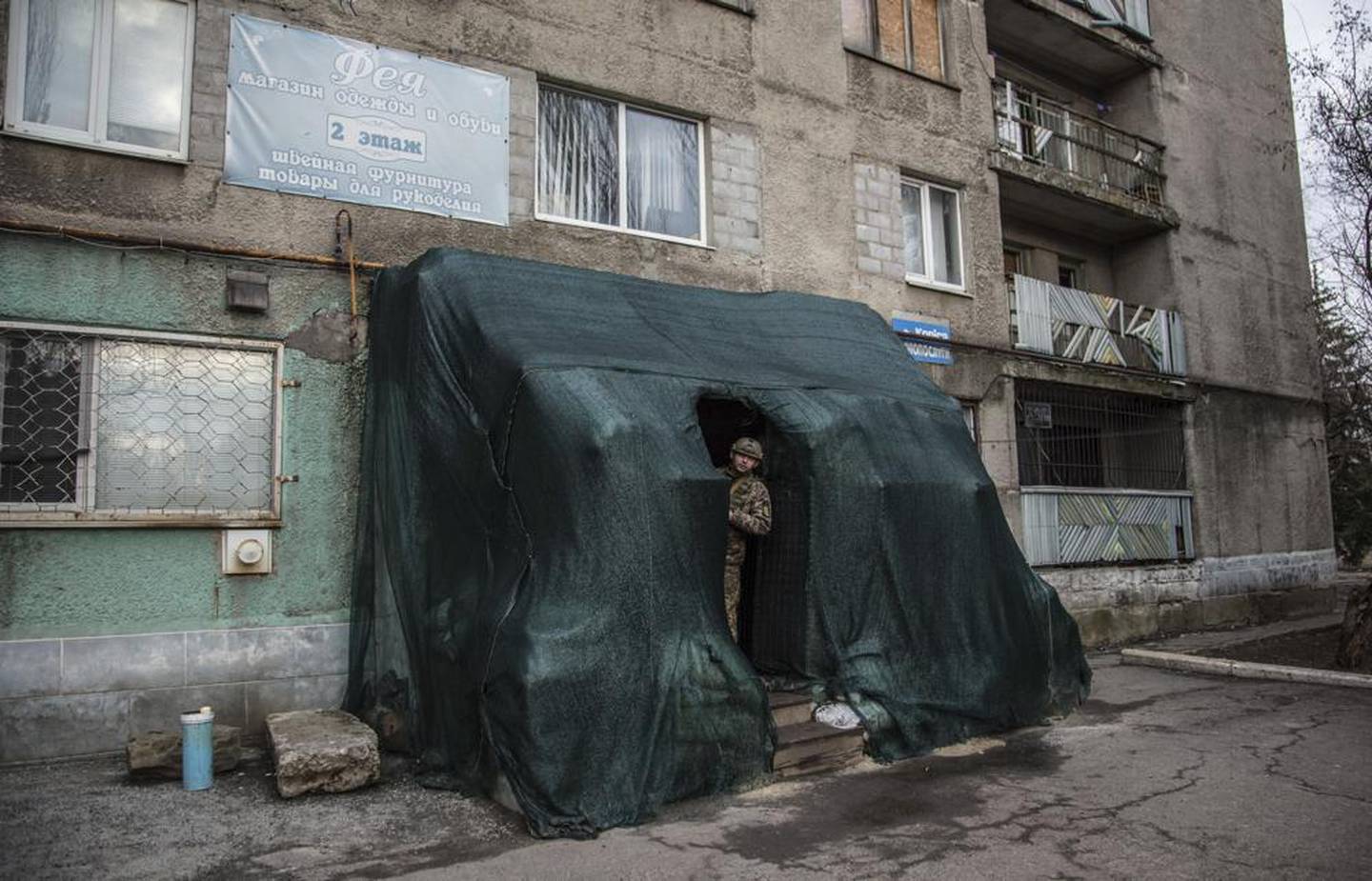 A Ukrainian soldier looks out of a shelter in the center of the village of Novoluhanske. Photo / AP