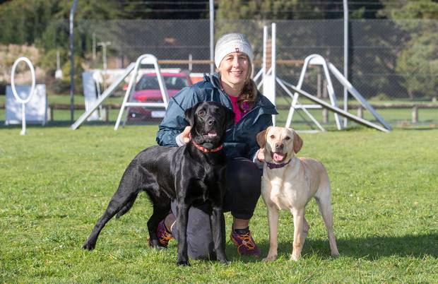 Erin Moyle, with Marco, left, who failed as a police dog, and Poppy, who is currently in training. Photo / Mark Mitchell