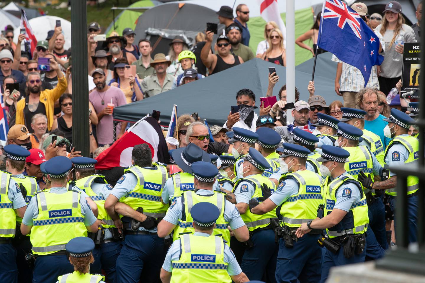 Anti-mandate protesters are held back after attempting to breach police lines at Parliament in Wellington. Photo / Mark Mitchell