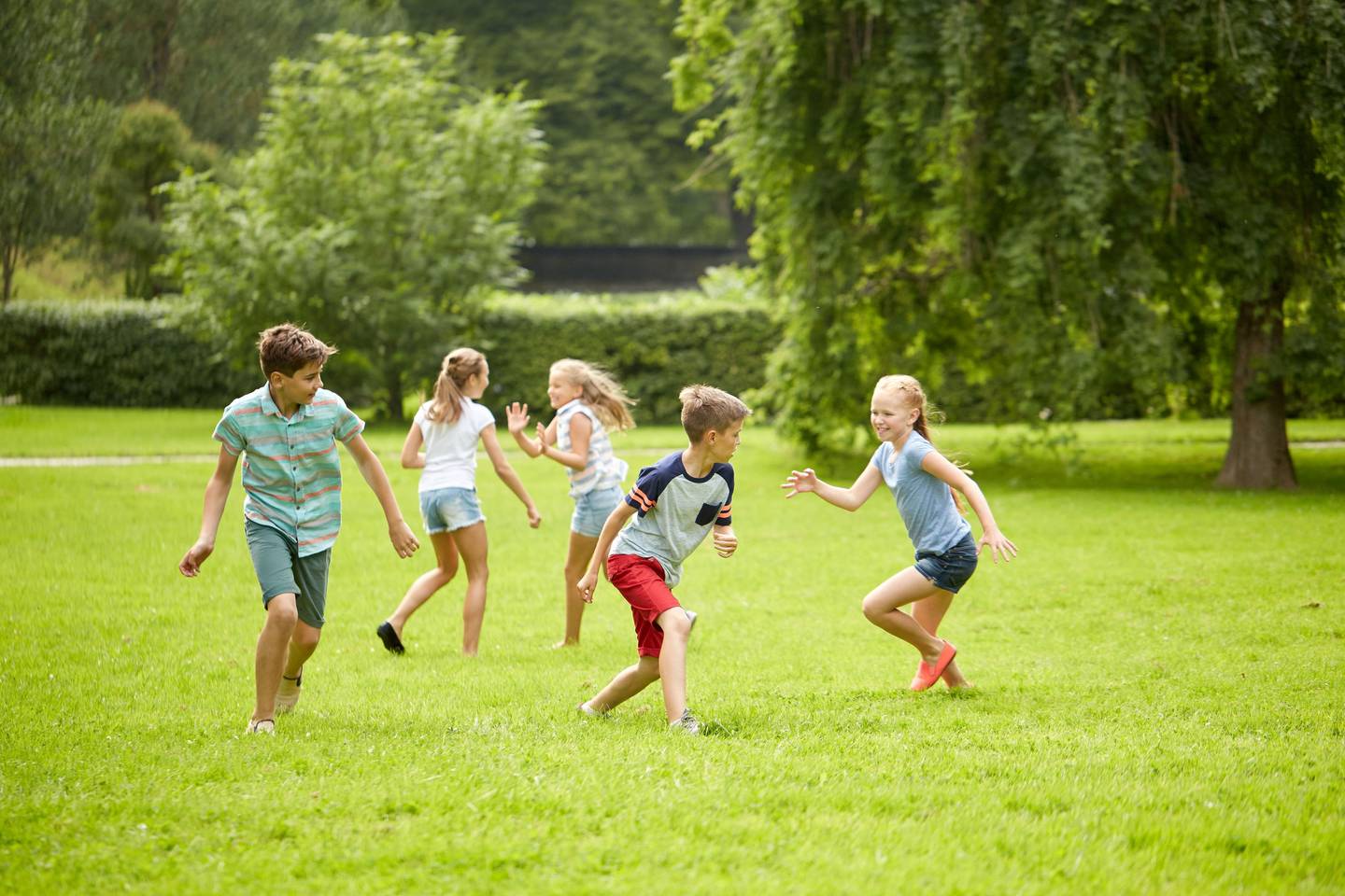 happy kids running and playing game outdoors