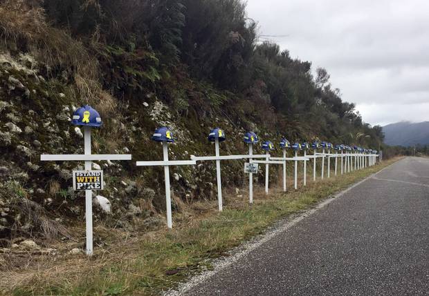 The 29 white crosses with miners' helmets lining the road to Pike River Mine, commemorating the 29 miners who died in November 2010. Photo / Kurt Bayer