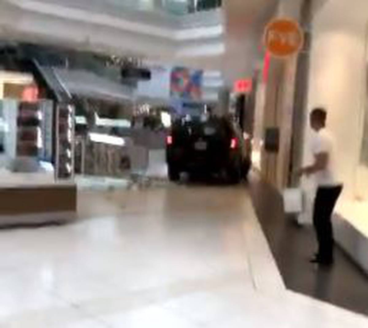Driver in custody after SUV crashes through shopping mall outside
