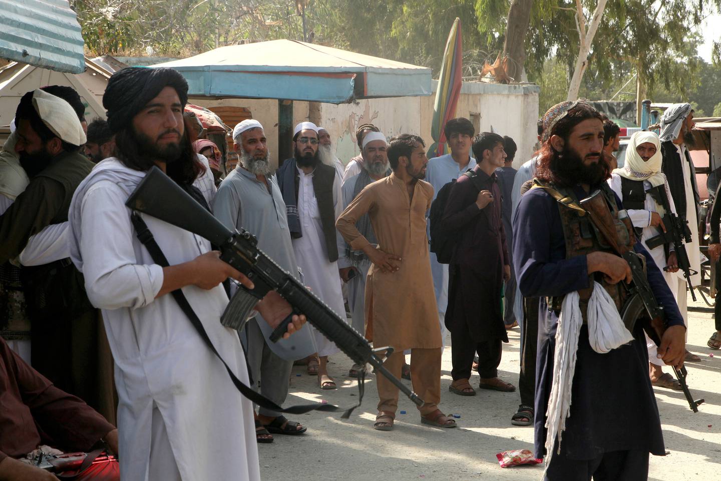 Taliban fighters stand guard on their side while people wait to cross at a border crossing point between Pakistan and Afghanistan, in Torkham, in Khyber district, Pakistan. Photo / AP