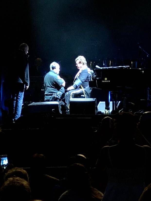 A medic appeared to take Elton John's blood pressure on stage as the singer battled to continue with the show while suffering pneumonia. Photo / Supplied
