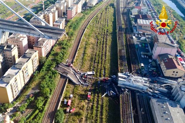 Rescue teams work among the rubble of the collapsed Morando highway bridge in Genoa, northern Italy. Photo / AP 