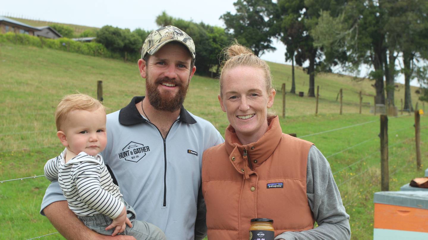 Hannah and Rory O'Brien with their son Mickey and their award-winning Kānuka honey. Photo / Danielle Zollickhofer