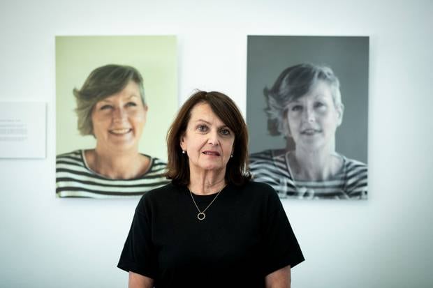 Sweet Louise chief executive Philippa Reed stands in front of images of Anna Southern, who was one of 100 members if the support group who have died since last October. Photo / Dean Purcell