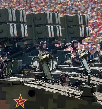 Chinese soldiers ride on armoured missile carriers as they pass in front of Tiananmen Square and the Forbidden City during a military parade in 2015. Photo / Getty Images