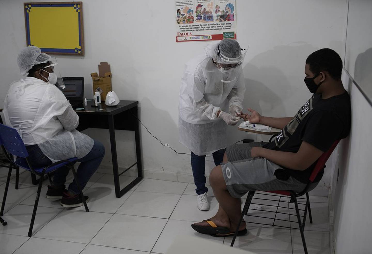 Health workers test a resident in Rio de Janeiro, Brazil. Photo / AP