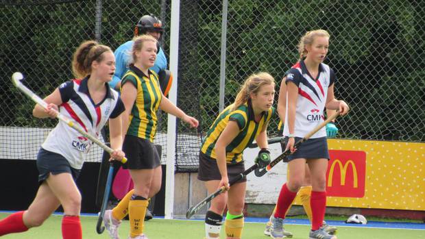 Whanganui High School players Olivia Smith (green and gold left) and Rebecca Baker loom large in the NPGH goal during the annual sporting exchange hockey clash won 32-27 by the visitors.