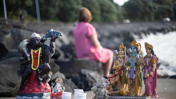 Rebecca at Biddick's Bay on Tamaki Drive, has been collecting Hindu deities left as rubbish on beaches. Photo / Jason Oxenham