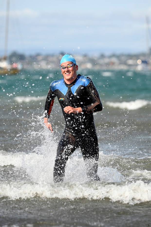 Rotorua's Davey Boles was all smiles as he exited the water in first place at the Round the Mount swim. Photo / George Novak