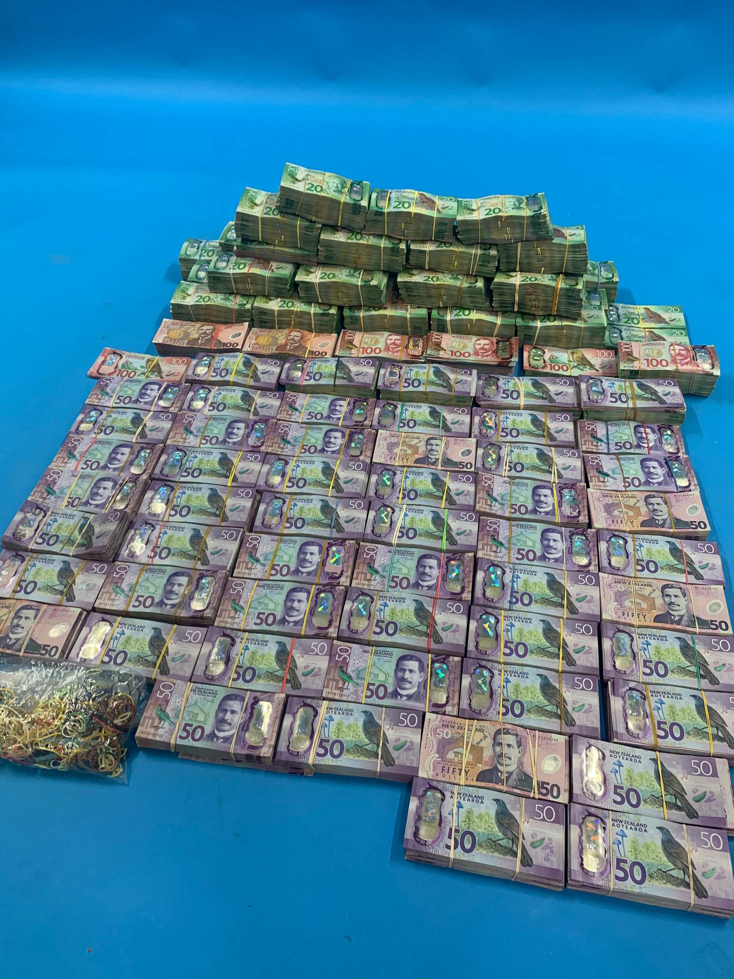 More than $1m cash was seized in New Zealand following the global coordinated sting on organised crime. Photo / NZ Police