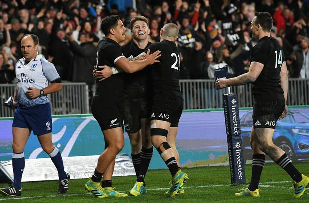 Beauden Barrett celebrates his try with Anton Lienert-Brown and TJ Perenara. Photo / Photosport
