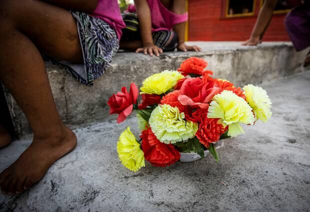 Flowers on the grave of Lagia Palu, 5, who died of measles. Photo / Mike Scott