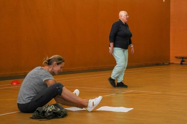 Ann Blackwell completes a walking test at Cycle Forward, while Pernille Lunn Erstad records her results.