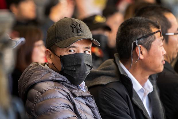 A supporter wears a mask at the Hong Kong protest held at the University of Auckland Quad. Photo / Peter Meecham