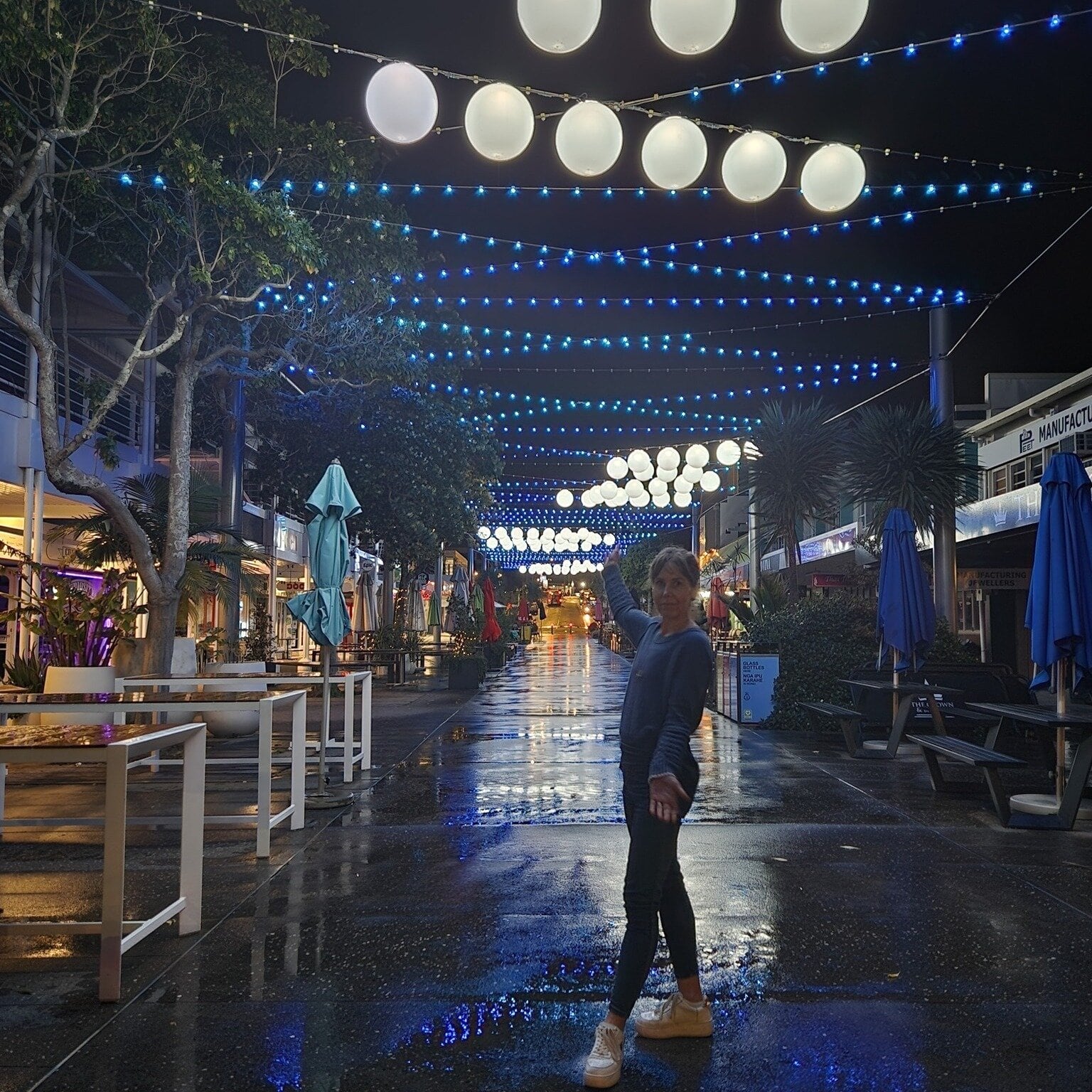  Mount Maunganui literacy tutor Heather Down under the blue lights at night in Wharf St, Tauranga.  