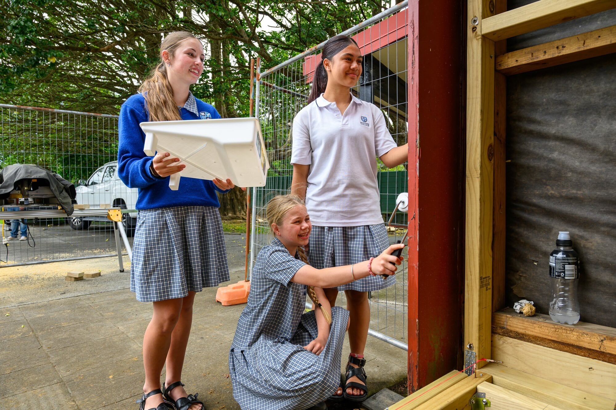  Year nine students Miné Leonard, Aria Tapsell, and Sofia-Wisdom Muliaga adding a fresh coat of paint to Te Wairoa Marae. Photo / David Hall