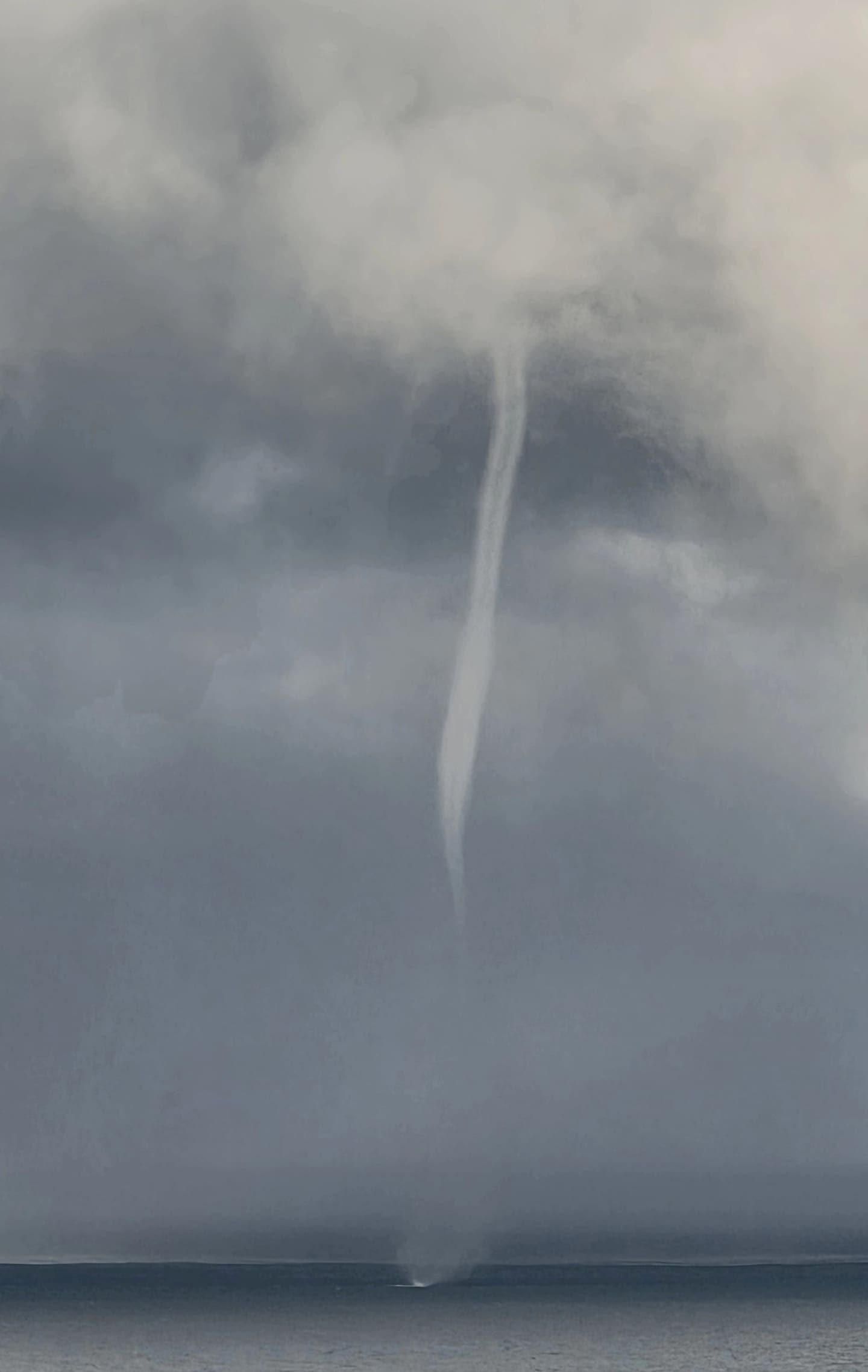 Robert said the waterspout was around 1km off the coast of Muriwai Beach. Photo / Robert Waddell