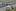 A column of Russian armored vehicles and trucks passes a heavily loaded car with a license plate of the separatist Georgian province of South Ossetia. Photo / AP