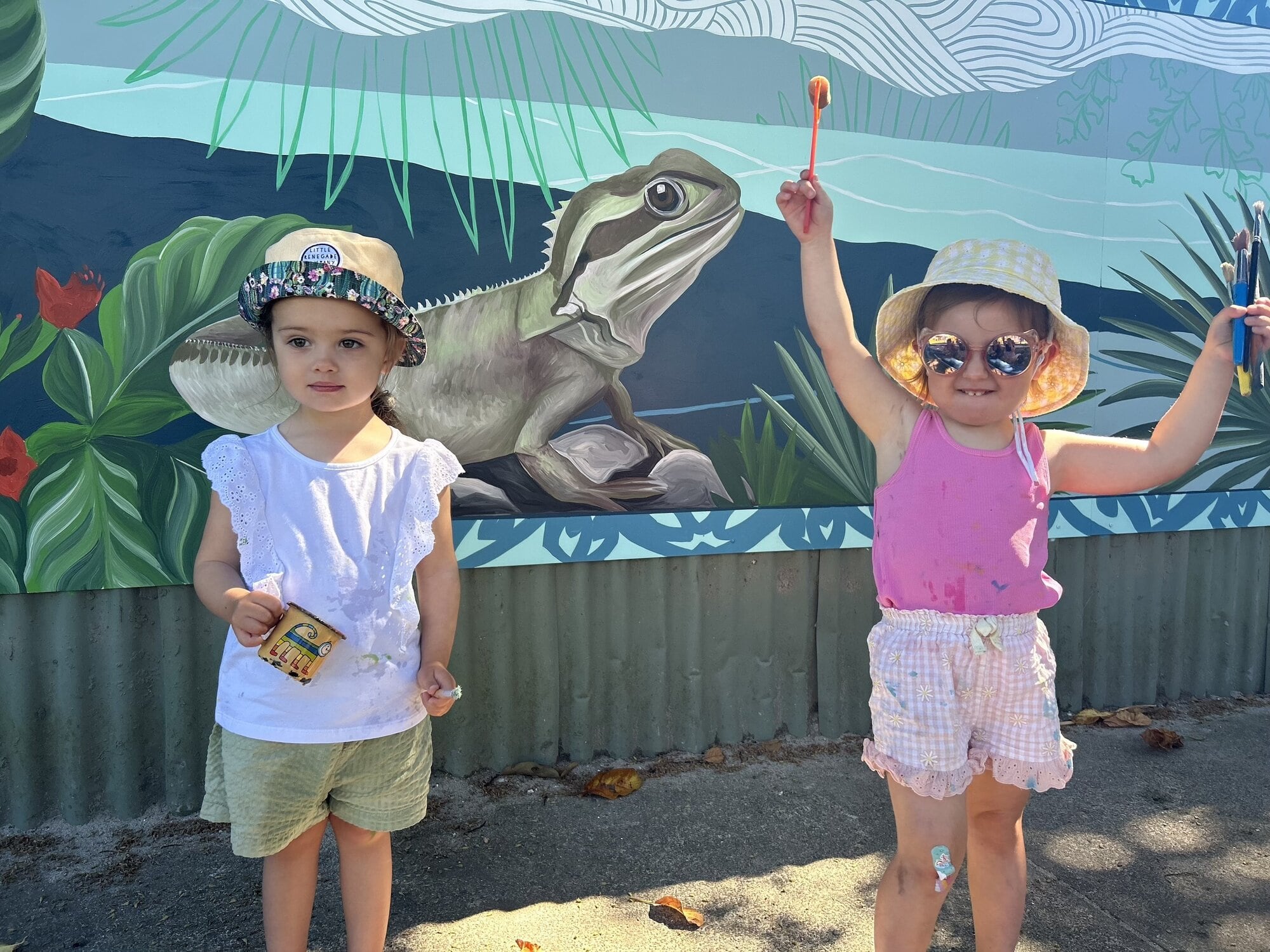  Neva Haynes-Dodd and Emma Spodyneiko in front of Ōtūmoetai Playcentre’s new mural. Photo / Supplied