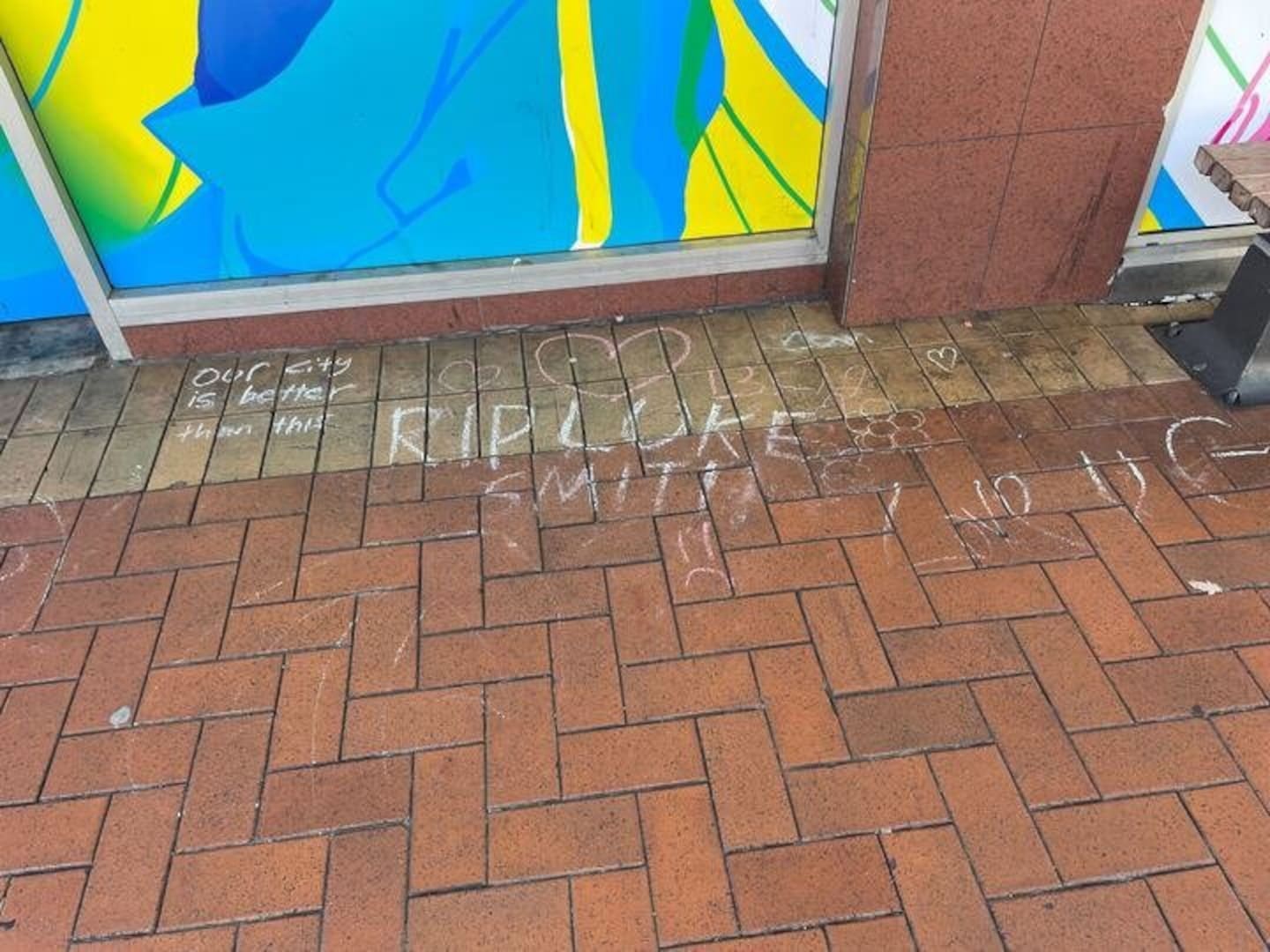 Chalk tributes have been left outside the old Reading Cinema complex on Courtenay Place, Wellington where Luke Smith was fatally assaulted. Photo / Azaria Howell