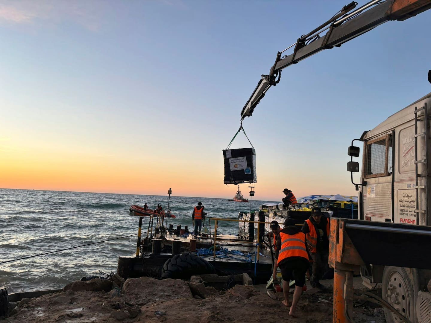 This photo provided by World Central Kitchen shows a crane unloading food packages over a makeshift port on the Gaza Strip. Photo / AP