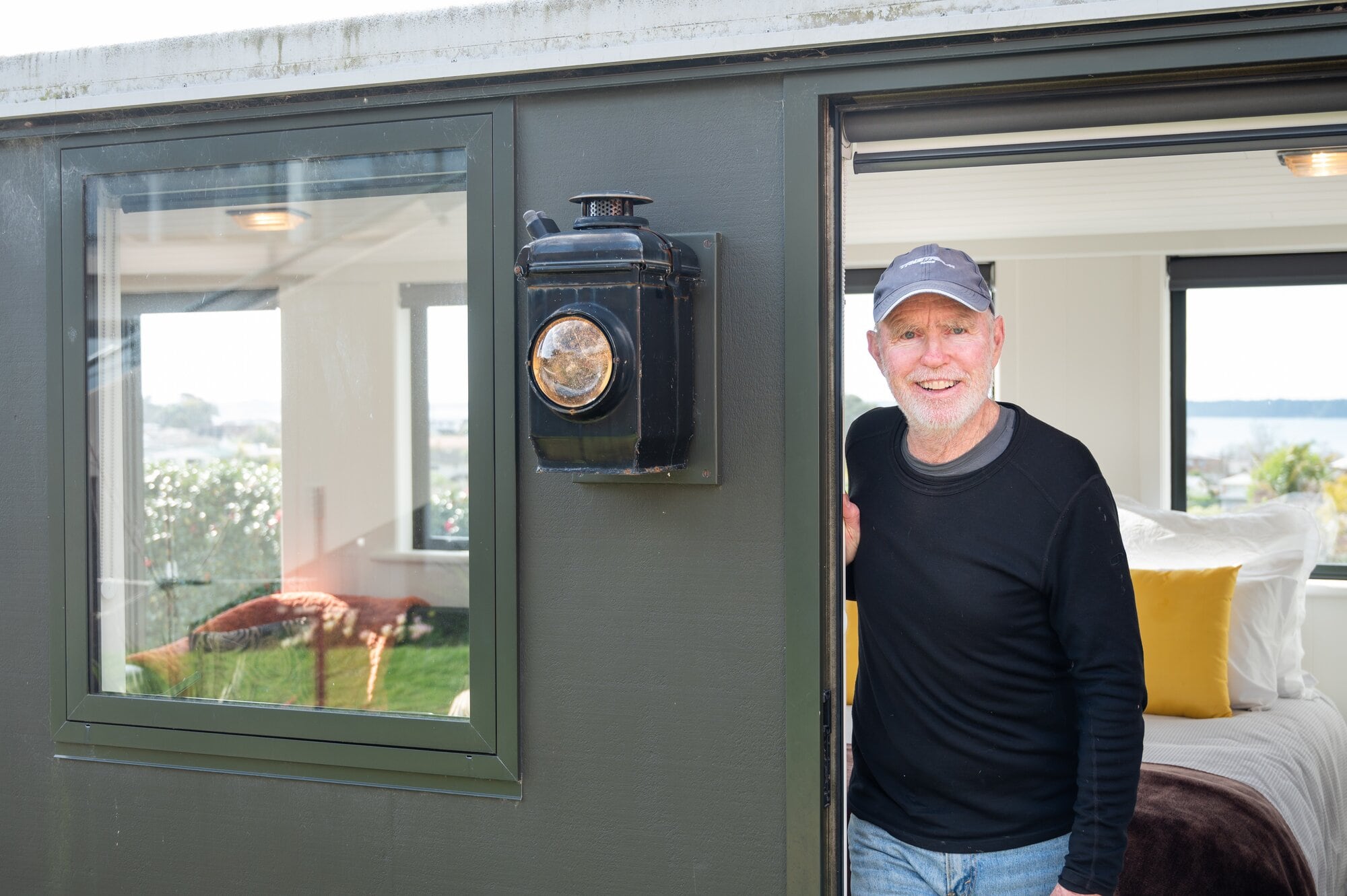  David Miller in the doorway of his railway sleeper carriage tiny house.  Photo / Brydie Thompson.