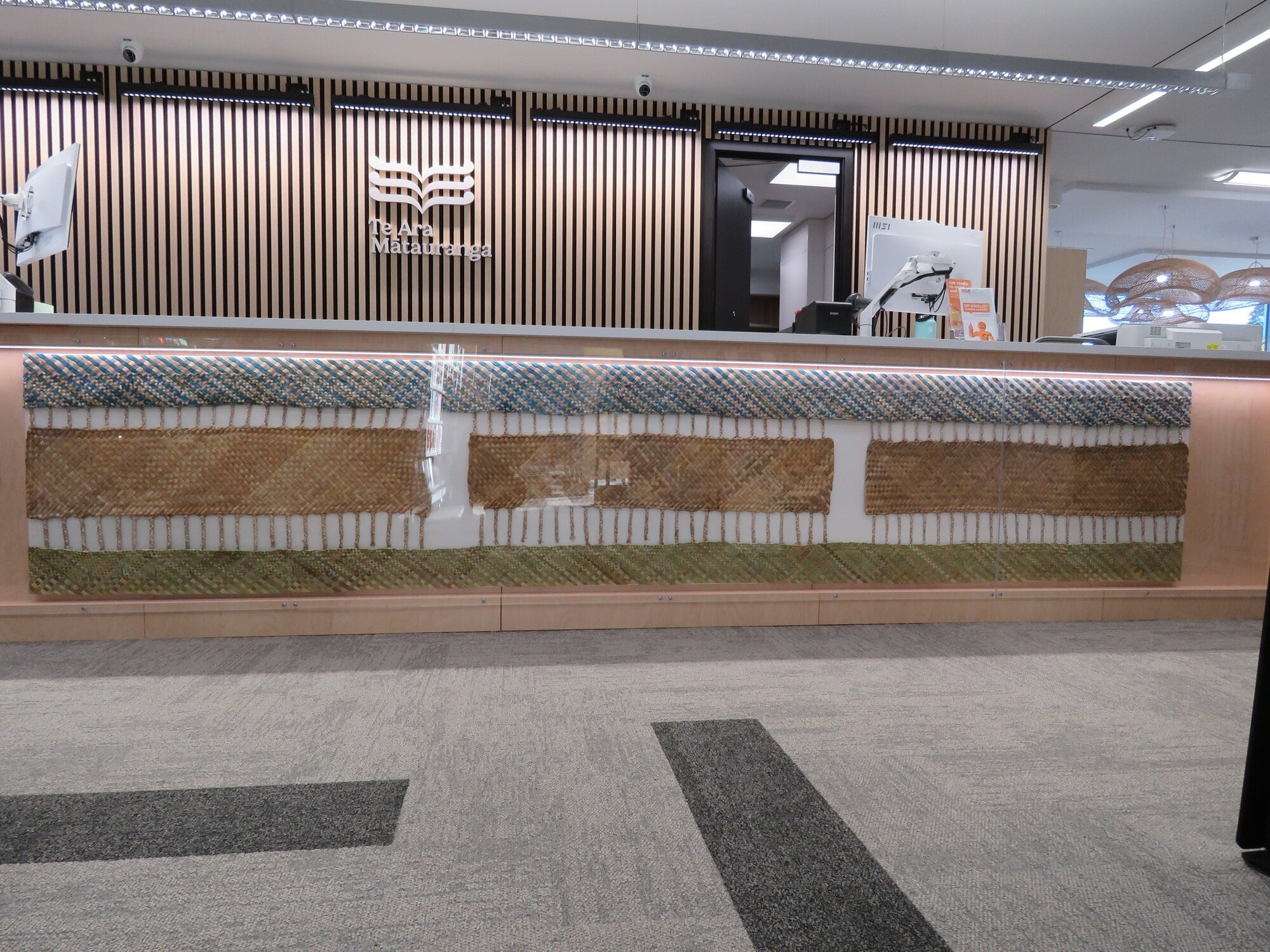  Ngā Tikanga o te Taiao’, weaved by Marino Magee, takes centre stage along the desk in Te Ara Mātauranga, Waihī Beach’s new library, service centre and community hub. Photo / Merle Cave