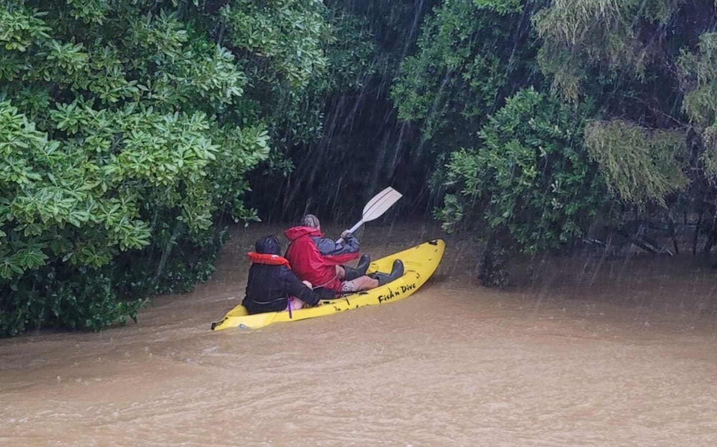 Jazmyn Welch (left) was rescued by a kayak from her flooded home in Kūaotunu on Wednesday morning. Photo / Peter de Graaf, RNZ