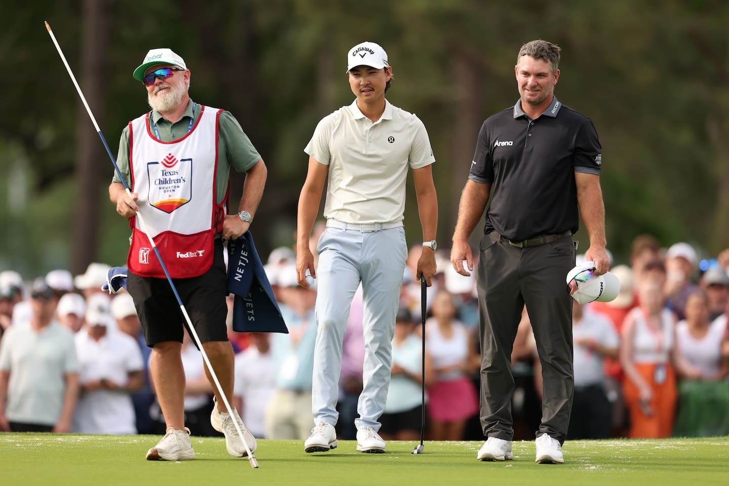 Min Woo Lee stands with his caddie Brian "Bo" Martin and Ryan Fox on the 18th hole during the final round of the Houston Open. Lee won the tournament by a shot. Photo / Getty Images