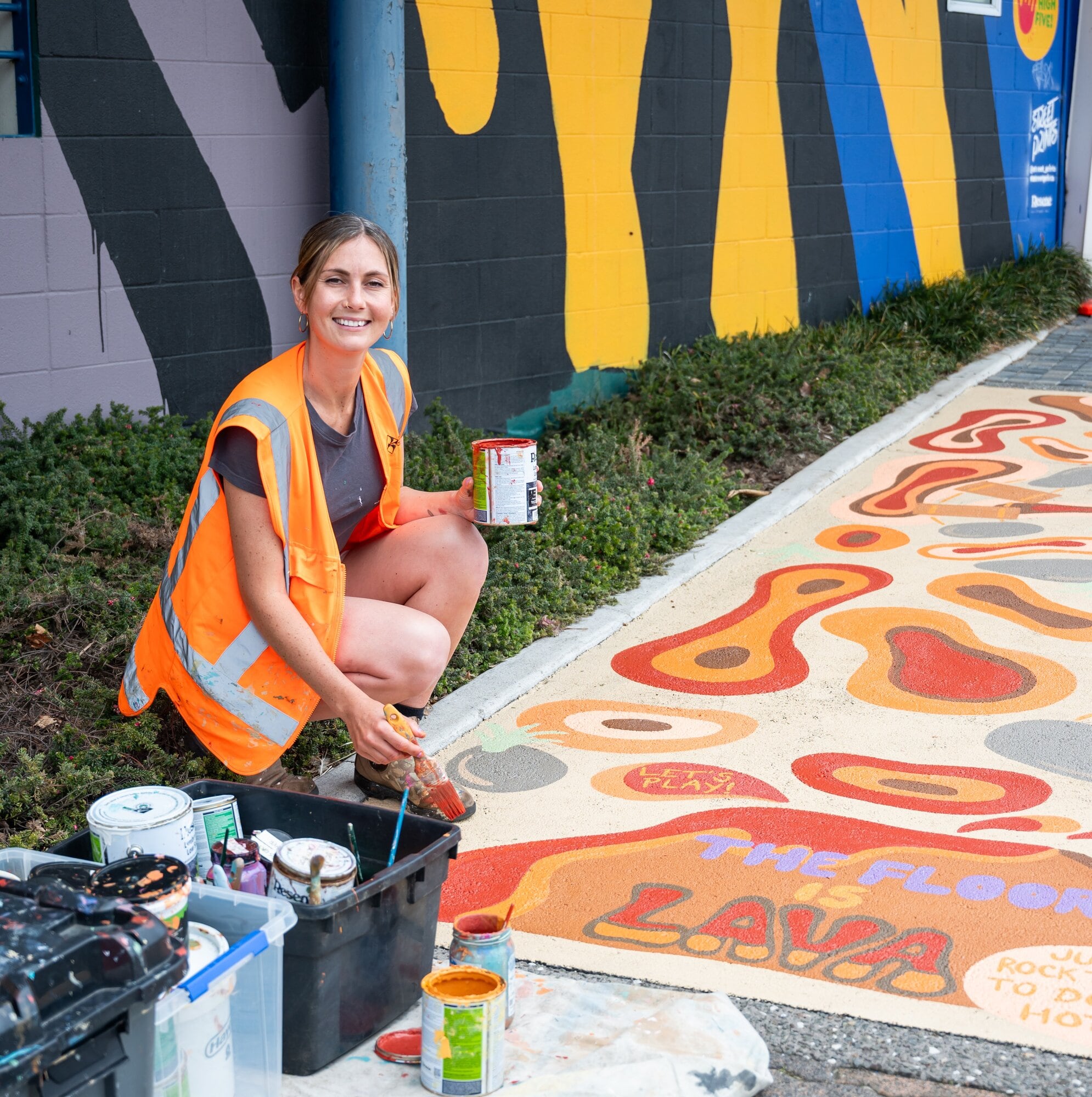  Muralist Sarah Jo Cornish painting ‘The Floor is Lava’ mural at the corner of Spring St and Durham St. Photo / Brydie Thompson